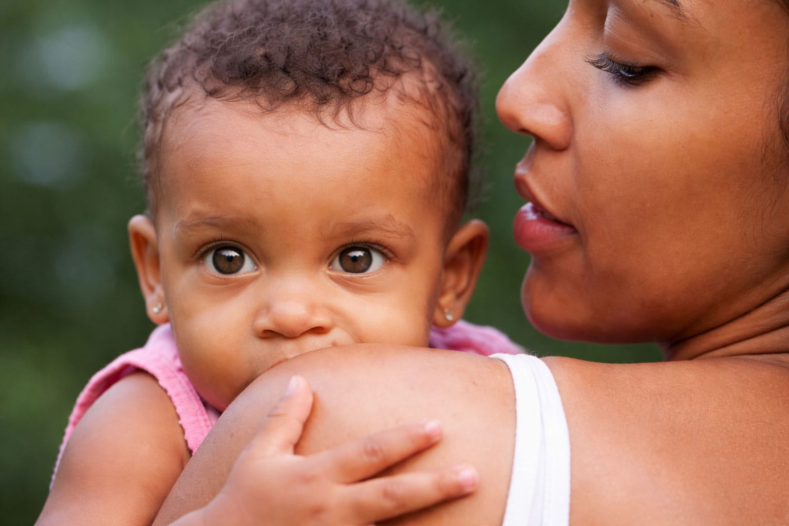 Mother and baby bond in sunlight